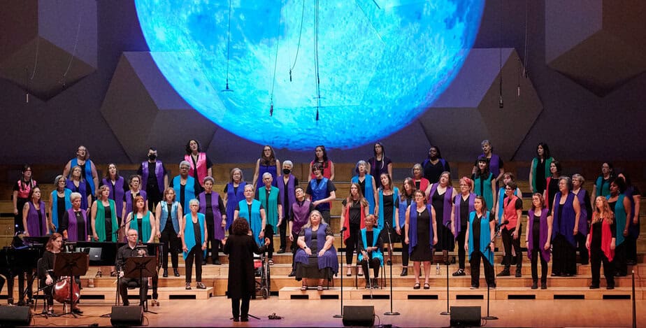 zoomed out photo of a choir singing